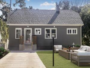 back of property featuring a yard and an outdoor hangout area