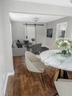 dining room featuring dark hardwood / wood-style flooring and a barn door