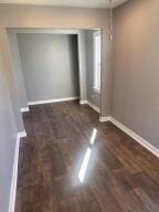 unfurnished bedroom with dark hardwood / wood-style floors