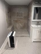 bathroom with walk in shower and vanity