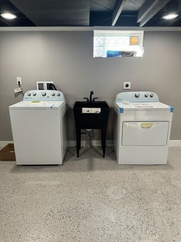 laundry area with sink and washing machine and clothes dryer