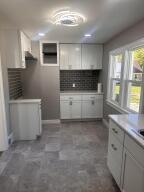 kitchen with white cabinets and backsplash