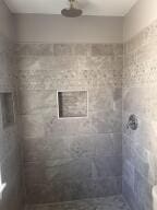 bathroom featuring a tile shower