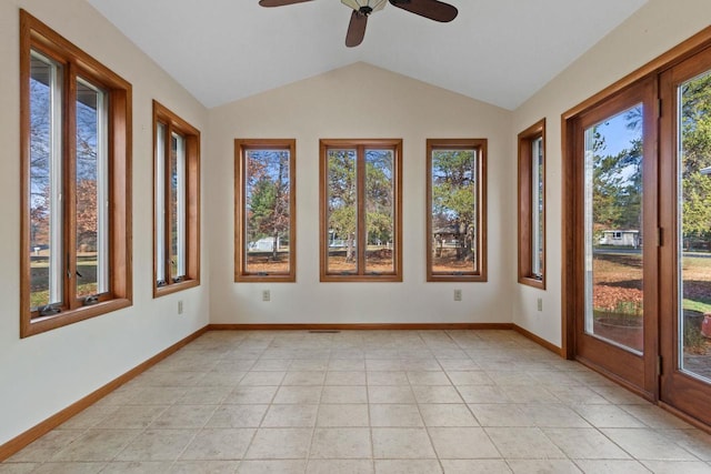 unfurnished sunroom featuring ceiling fan, vaulted ceiling, and plenty of natural light