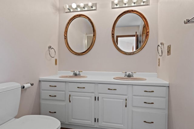 bathroom featuring toilet and vanity