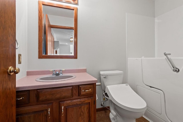 bathroom featuring toilet, vanity, and tile patterned flooring