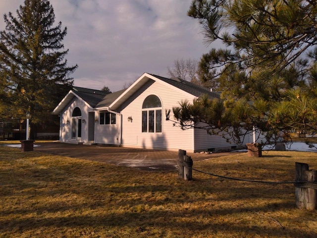 property exterior at dusk with a yard