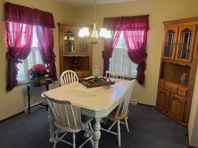 carpeted dining room with a chandelier