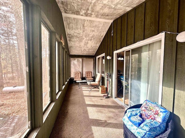 unfurnished sunroom featuring vaulted ceiling