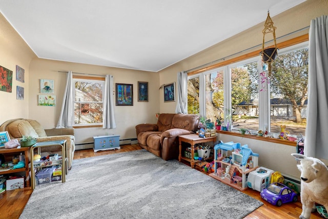 recreation room featuring hardwood / wood-style flooring and baseboard heating