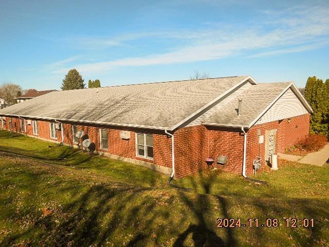 rear view of property with a lawn