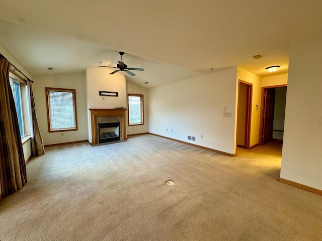 unfurnished living room featuring light colored carpet, ceiling fan, and lofted ceiling