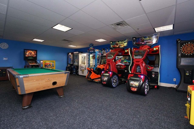 playroom featuring dark carpet and a drop ceiling