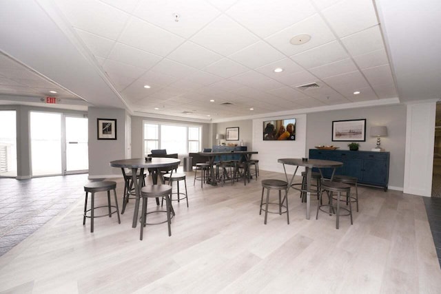 dining room with light hardwood / wood-style floors and ornamental molding