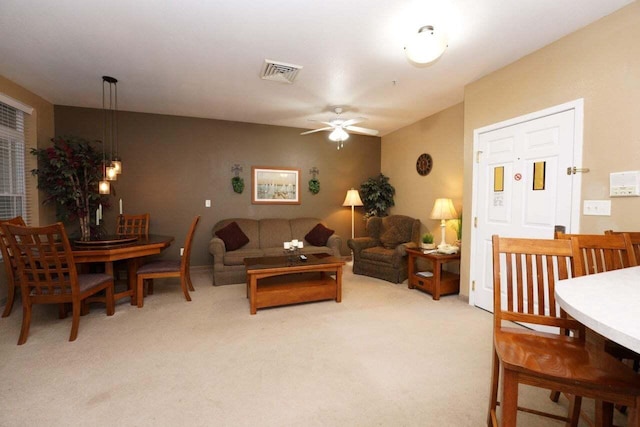 carpeted living room featuring ceiling fan