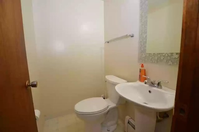 bathroom featuring a baseboard radiator and toilet