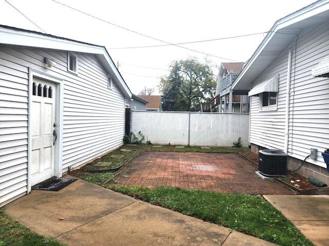 view of yard featuring central AC unit and a patio area