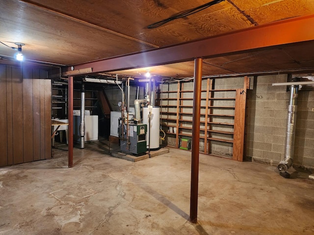 basement with washer and clothes dryer and water heater