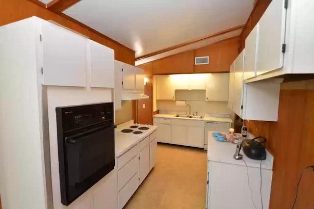 kitchen featuring vaulted ceiling, sink, white cabinets, and white appliances