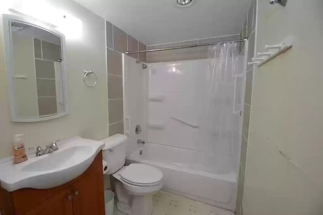 full bathroom featuring vanity, shower / tub combo, and toilet