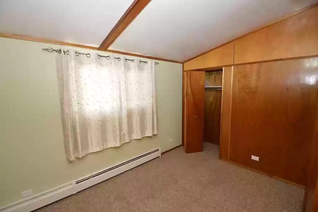 unfurnished bedroom featuring a closet, light colored carpet, a baseboard radiator, and lofted ceiling