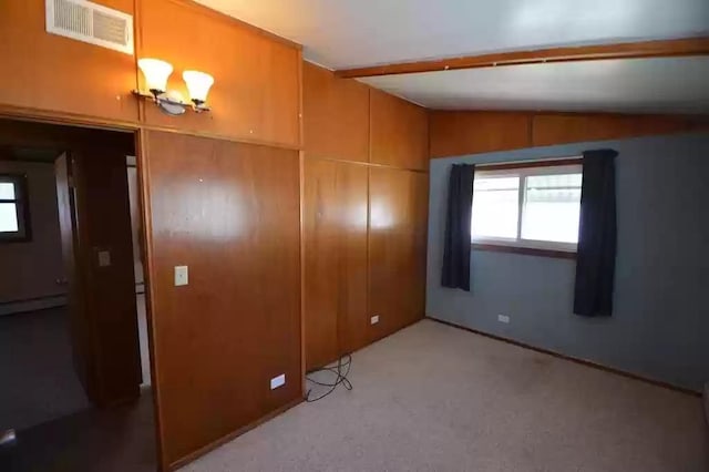 unfurnished bedroom featuring lofted ceiling with beams