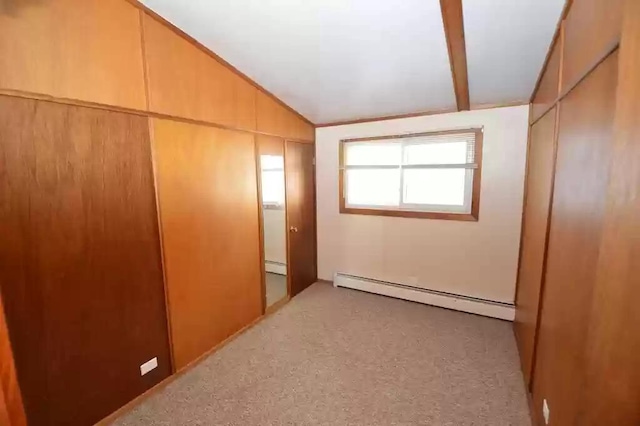 interior space featuring a baseboard radiator and vaulted ceiling