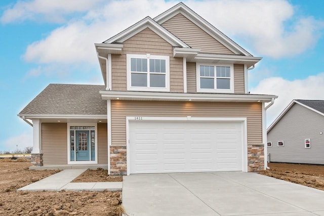1411 Tamarack St, Delavan, WI 53115 - craftsman-style home featuring stone siding, an attached garage, and concrete driveway
