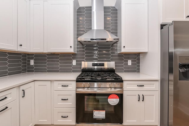 kitchen with backsplash, wall chimney exhaust hood, white cabinetry, and stainless steel appliances