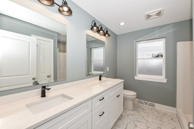 bathroom featuring vanity and toilet