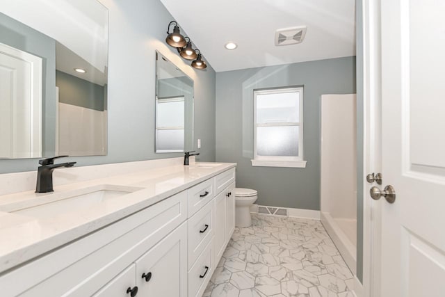 1411 Tamarack St, Delavan, WI 53115 - bathroom featuring double vanity, marble look tile flooring, and a shower