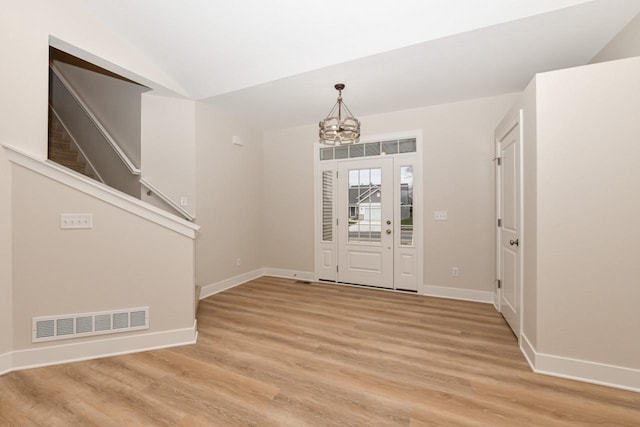 1411 Tamarack St, Delavan, WI 53115 - entryway featuring a chandelier, light wood-style floors, and vaulted ceiling