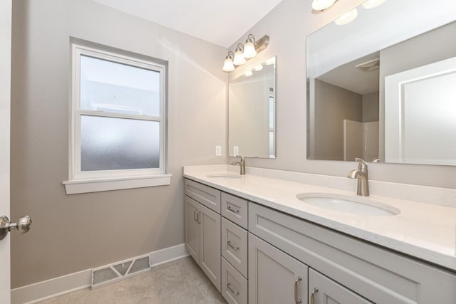 1411 Tamarack St, Delavan, WI 53115 - bathroom featuring double vanity and marble look tiles