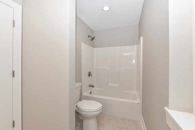 bathroom featuring tile patterned flooring, shower / bathing tub combination, and toilet