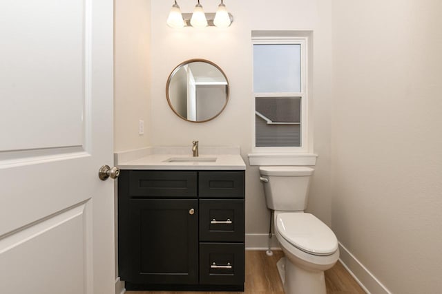 bathroom featuring hardwood / wood-style floors, vanity, and toilet