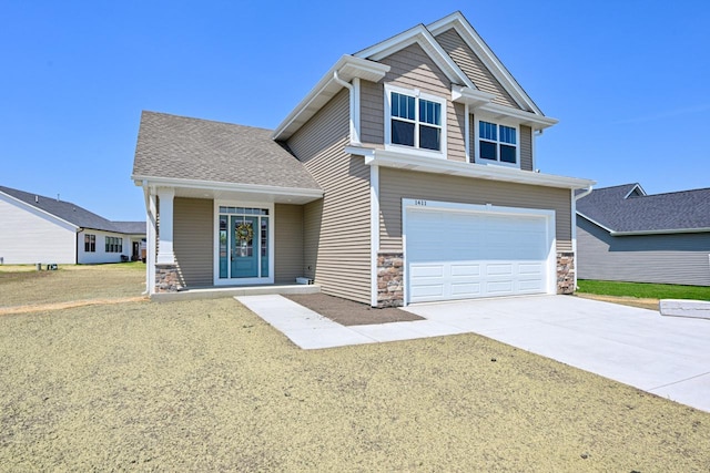1411 Tamarack St, Delavan, WI 53115 - craftsman inspired home featuring a garage, driveway, and stone siding