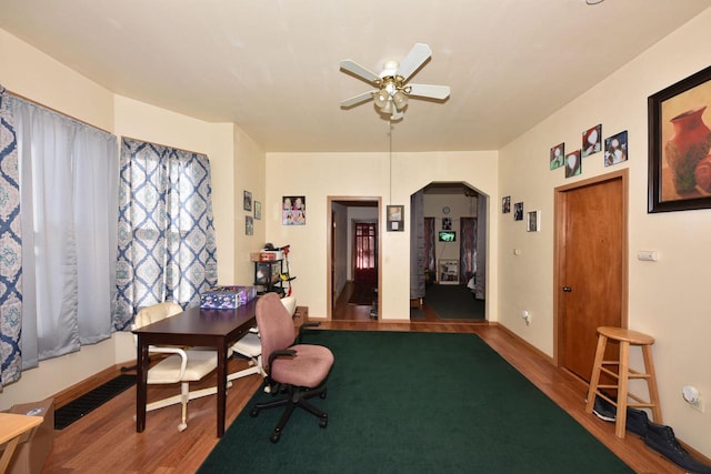 interior space with ceiling fan and wood-type flooring