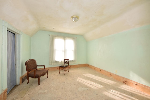 sitting room with lofted ceiling