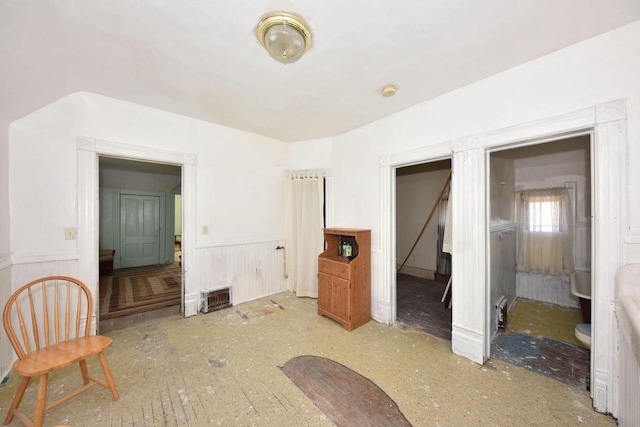 bedroom featuring wood walls