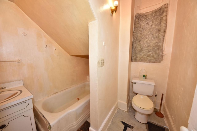 bathroom with vanity, toilet, and a tub