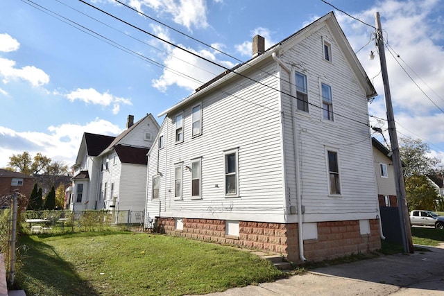 view of property exterior with a yard