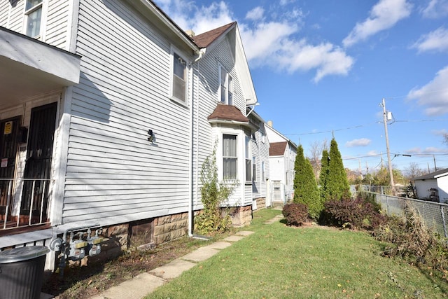 view of side of property with a lawn