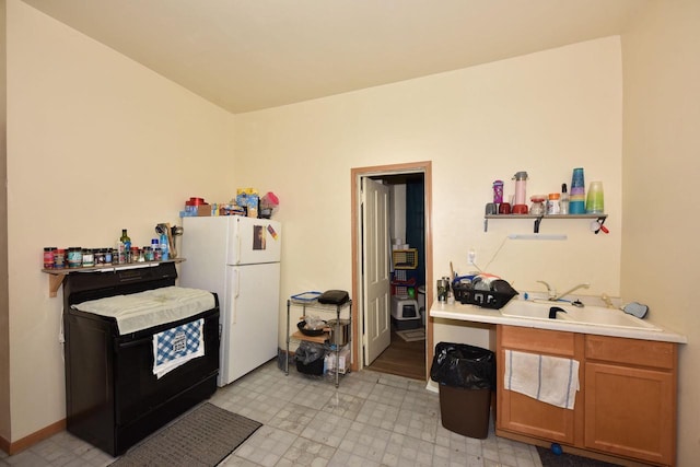 kitchen with sink and white refrigerator