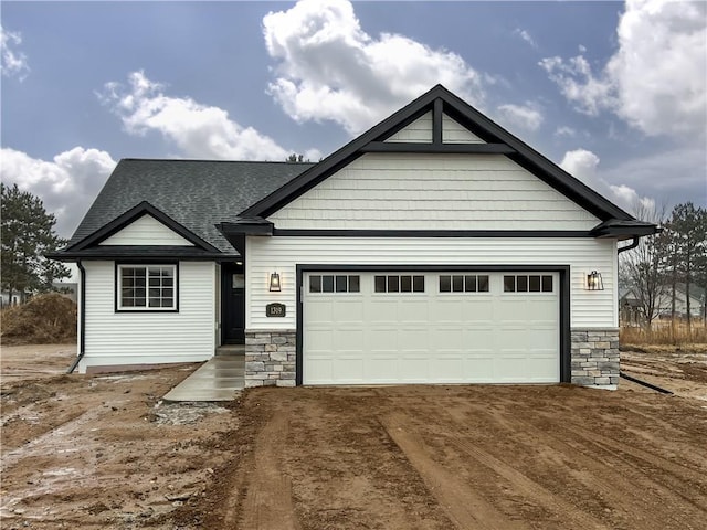 1319 Carli Ct Lot 80, Chippewa Falls, WI 54729 - craftsman-style home featuring stone siding, a shingled roof, driveway, and a garage