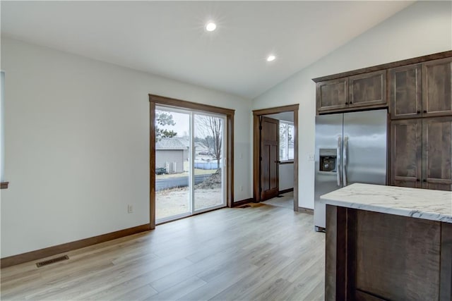 1319 Carli Ct Lot 80, Chippewa Falls, WI 54729 - kitchen featuring stainless steel fridge with ice dispenser, lofted ceiling, light wood-type flooring, light stone countertops, and recessed lighting