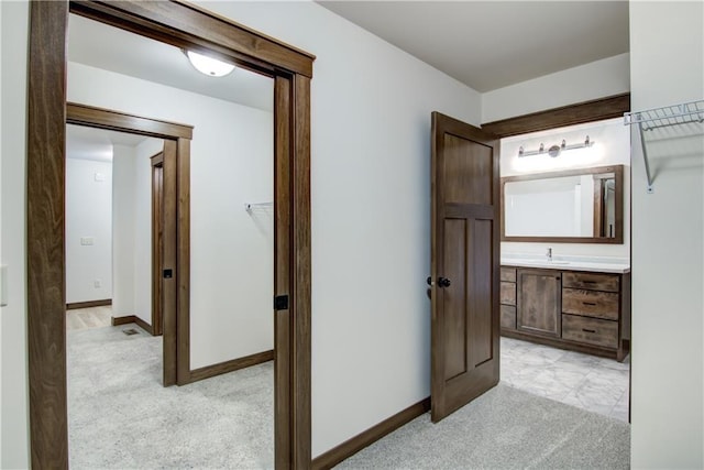 1319 Carli Ct Lot 80, Chippewa Falls, WI 54729 - corridor with light carpet, a sink, and baseboards