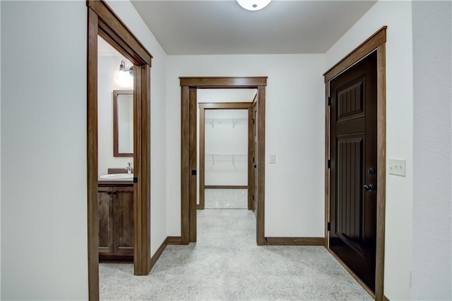 1319 Carli Ct Lot 80, Chippewa Falls, WI 54729 - hallway featuring baseboards, a sink, and light carpet