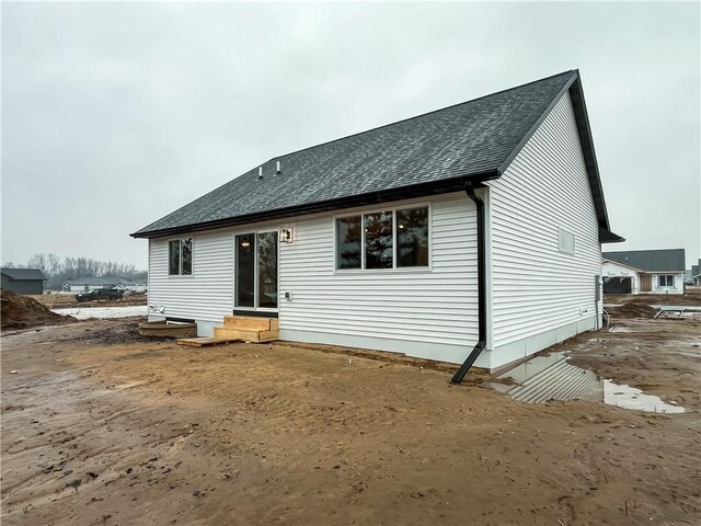 1319 Carli Ct Lot 80, Chippewa Falls, WI 54729 - rear view of house featuring a shingled roof and entry steps