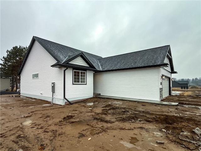 1319 Carli Ct Lot 80, Chippewa Falls, WI 54729 - view of side of home featuring roof with shingles and an attached garage