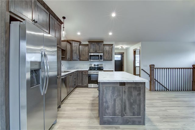 1319 Carli Ct Lot 80, Chippewa Falls, WI 54729 - kitchen with stainless steel appliances, a kitchen island, dark brown cabinets, light wood finished floors, and recessed lighting